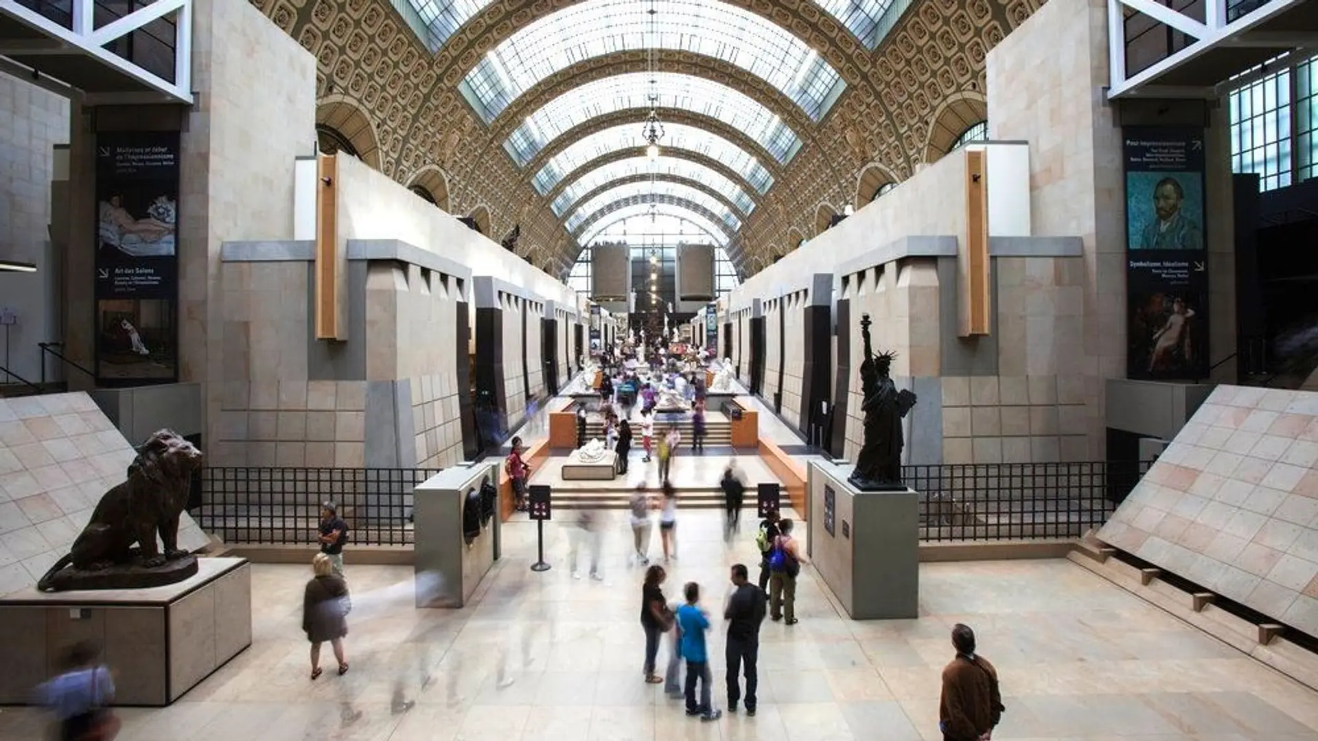 Inside Musee d'Orsay with sculptures and people.